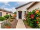 Inviting home featuring a desert landscape and front walkway to entrance with mature plants at 26145 W Runion Dr, Buckeye, AZ 85396