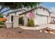 Inviting home featuring a desert landscape, gated courtyard and an attached garage at 26145 W Runion Dr, Buckeye, AZ 85396