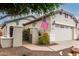 Inviting home featuring a desert landscape, gated courtyard and an attached garage at 26145 W Runion Dr, Buckeye, AZ 85396