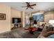 Comfortable living room with a ceiling fan, stylish rug and open-concept design at 26145 W Runion Dr, Buckeye, AZ 85396