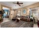 Warm living room featuring a ceiling fan, accent rug and comfortable furnishings at 26145 W Runion Dr, Buckeye, AZ 85396
