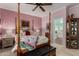 Elegant primary bedroom features a four-poster bed, ceiling fan, and decorative accents at 26145 W Runion Dr, Buckeye, AZ 85396