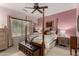 Elegant primary bedroom features a four-poster bed, ceiling fan, and decorative accents at 26145 W Runion Dr, Buckeye, AZ 85396
