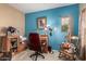 Home office with blue accent wall and comfortable seating, ready for work or study at 26145 W Runion Dr, Buckeye, AZ 85396