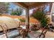 Outdoor patio area with a dining table set, shaded by a covered structure at 26145 W Runion Dr, Buckeye, AZ 85396