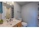 Well-lit bathroom with modern fixtures, vanity, and open shelving for storage at 2625 N 40Th Dr, Phoenix, AZ 85009