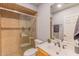 Updated bathroom with tiled shower and modern vanity, featuring neutral colors and finishes at 2625 N 40Th Dr, Phoenix, AZ 85009