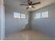 Well-lit bedroom offers tiled floors, ceiling fan, and abundant natural light at 2625 N 40Th Dr, Phoenix, AZ 85009