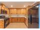 Modern kitchen boasts sleek black appliances, quartz countertops, and ample cabinet space at 2625 N 40Th Dr, Phoenix, AZ 85009