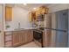 Modern kitchen with stainless steel appliances, light wood cabinets, and quartz countertops at 2625 N 40Th Dr, Phoenix, AZ 85009