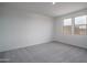 Bright bedroom with plush carpeting, two large windows, and plenty of natural light at 2823 N 212Th Dr, Buckeye, AZ 85396