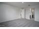 Spacious room with plush carpeting and an open doorway leading to other parts of the home at 2823 N 212Th Dr, Buckeye, AZ 85396