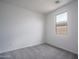 This is a secondary carpeted bedroom that features natural light from a window with neighborhood views at 2823 N 212Th Dr, Buckeye, AZ 85396