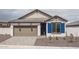 Charming single-story home featuring a two-car garage and a well-maintained, low-water, front yard at 2823 N 212Th Dr, Buckeye, AZ 85396