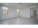 Bright and airy living room with large windows, recessed lighting, and ceramic tile flooring at 2823 N 212Th Dr, Buckeye, AZ 85396