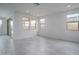Bright and airy living room with large windows, recessed lighting, and ceramic tile flooring at 2823 N 212Th Dr, Buckeye, AZ 85396