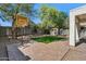 Backyard featuring a sports court, brick, playhouse, and lush trees at 2851 W Gold Dust Ave, San Tan Valley, AZ 85144