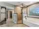 Bright bathroom featuring a tiled shower, separate soaking tub, and a window with natural light at 2851 W Gold Dust Ave, San Tan Valley, AZ 85144