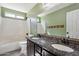 Bathroom featuring dual sinks and vanity with decorative wall accents at 2851 W Gold Dust Ave, San Tan Valley, AZ 85144
