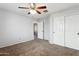 Bedroom featuring a ceiling fan and carpeted floor with white closet doors at 2851 W Gold Dust Ave, San Tan Valley, AZ 85144