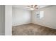 Neutral bedroom with a ceiling fan, window, and carpeted floor at 2851 W Gold Dust Ave, San Tan Valley, AZ 85144