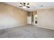Large bedroom with plush carpet and open view of an en-suite bathroom at 2851 W Gold Dust Ave, San Tan Valley, AZ 85144