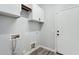 Well-lit laundry room with white cabinets and modern flooring at 2851 W Gold Dust Ave, San Tan Valley, AZ 85144