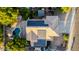 Aerial view of a home with solar panels, pool, mature trees, and a well-maintained roof at 288 W Los Alamos St, Gilbert, AZ 85233