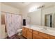 Bathroom featuring double sinks, large vanity, and a shower with curtain at 288 W Los Alamos St, Gilbert, AZ 85233