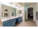Primary bathroom with double vanity, tile floors, walk in closet, and access to primary bedroom at 288 W Los Alamos St, Gilbert, AZ 85233