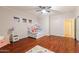 Bedroom with wood floors, ceiling fan, and a window providing natural light at 288 W Los Alamos St, Gilbert, AZ 85233