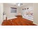 Bedroom with wood floors, ceiling fan, and a window providing natural light at 288 W Los Alamos St, Gilbert, AZ 85233