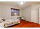 Bedroom with a window, modern ceiling fan, and wood-look floors at 288 W Los Alamos St, Gilbert, AZ 85233