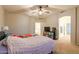 Spacious bedroom features a ceiling fan and an open doorway to another room and an en-suite bathroom at 288 W Los Alamos St, Gilbert, AZ 85233