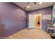 A versatile bedroom with tile floors, closet access, and neutral purple walls that can be customized to suit any style at 288 W Los Alamos St, Gilbert, AZ 85233