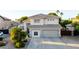 Charming two-story home with a well-manicured lawn, a two-car garage, and a welcoming entrance at 288 W Los Alamos St, Gilbert, AZ 85233