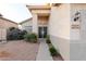 The home features a charming facade with decorative door and well-maintained desert landscaping for great curb appeal at 288 W Los Alamos St, Gilbert, AZ 85233