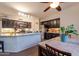 Lovely eat-in kitchen features granite countertops, stainless appliances, dark cabinetry, and tile floors at 288 W Los Alamos St, Gilbert, AZ 85233