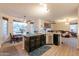 Open concept kitchen offers an island with seating, stainless steel appliances and a seamless flow into the dining area at 288 W Los Alamos St, Gilbert, AZ 85233