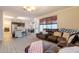 Inviting living room featuring tile floors, a comfortable leather sectional, and an open layout to the kitchen at 288 W Los Alamos St, Gilbert, AZ 85233