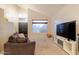 Bright living room with natural lighting and a large television at 288 W Los Alamos St, Gilbert, AZ 85233