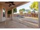 Covered patio with wrought iron fence offers a view of a backyard pool and a playset for outdoor enjoyment at 288 W Los Alamos St, Gilbert, AZ 85233