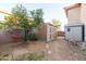 Backyard features a convenient storage shed and mature orange tree, providing practicality and natural beauty at 288 W Los Alamos St, Gilbert, AZ 85233