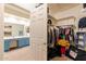 Large walk-in closet with open door to bathroom at 288 W Los Alamos St, Gilbert, AZ 85233
