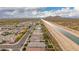 Expansive aerial view showcasing a community with mountain views and a nearby canal at 28931 N 64Th Dr, Phoenix, AZ 85083