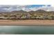 Scenic aerial view of a residential neighborhood with mountain views and irrigation canal at 28931 N 64Th Dr, Phoenix, AZ 85083