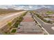 Wide scenic aerial view of a residential neighborhood with mountain views and irrigation canal at 28931 N 64Th Dr, Phoenix, AZ 85083