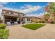 Expansive backyard with artificial turf, covered patio, and beautiful landscaping at 28931 N 64Th Dr, Phoenix, AZ 85083