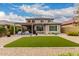 Spacious backyard featuring artificial turf, covered patio, and meticulously maintained landscaping at 28931 N 64Th Dr, Phoenix, AZ 85083