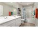 Well-lit bathroom with double sink vanity, tile flooring, and a shower-tub combo with marine-themed curtain at 28931 N 64Th Dr, Phoenix, AZ 85083